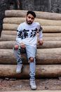 Man in White and Black Long Sleeve Shirt Sitting on Brown Wooden Stairs