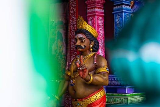 Vibrant Hindu statue at Batu Caves in Malaysia with intricate traditional decorations.