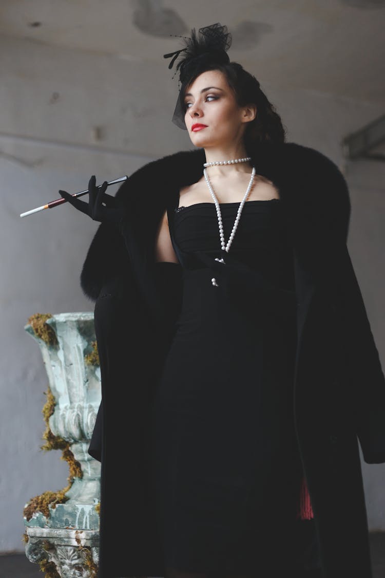 Woman In Black Clothes With Long Pipe