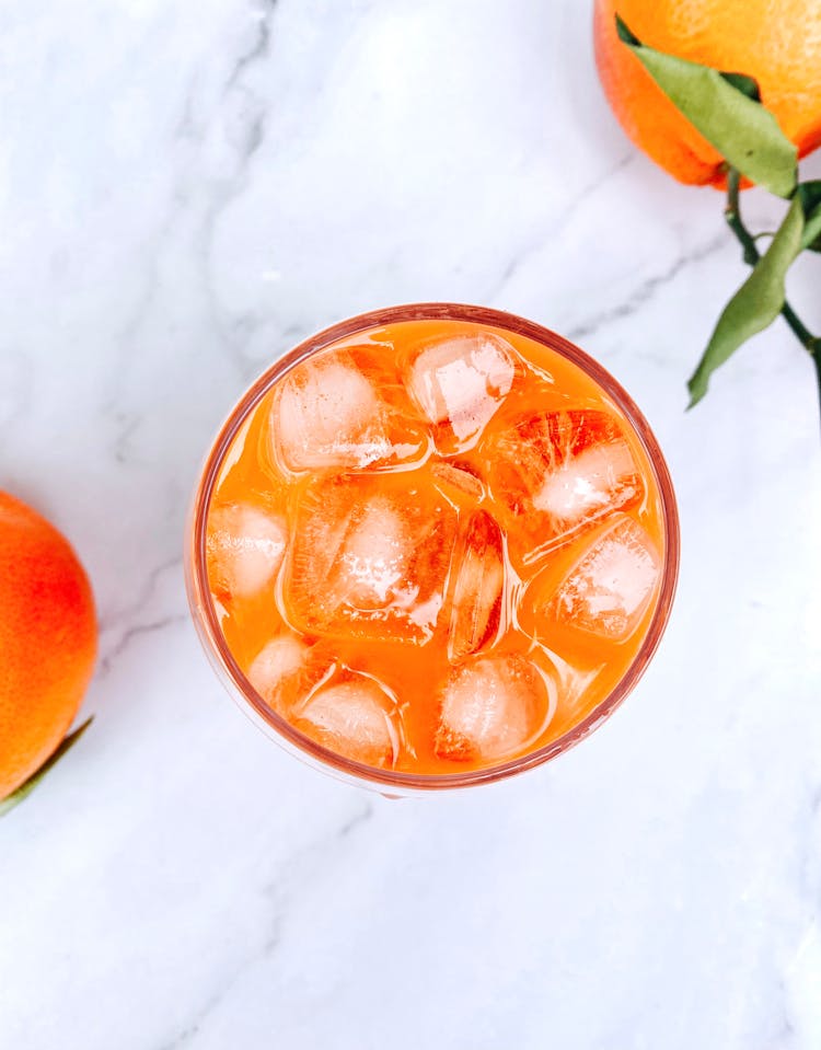 Flat Lay Shot Of Orange Juice With Ice