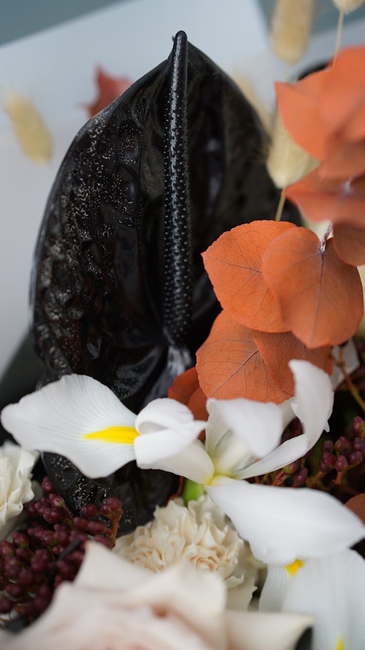 Floral Composition Of Black Calla Orange Leaves And White Iris