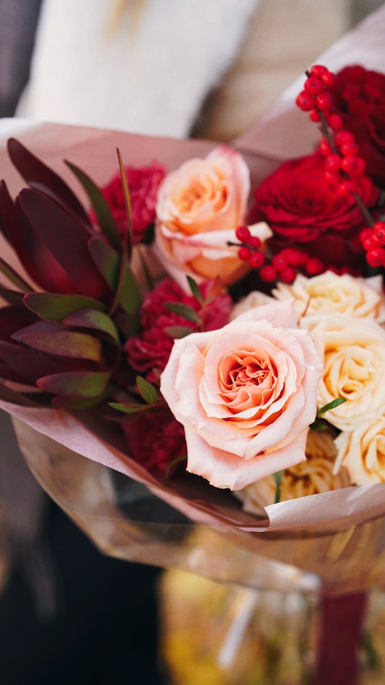 Bunch Of Pink And Red Flowers Wrapped In Ornamental Foil And Paper