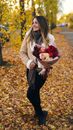 Young Woman Posing with Bouquet in Autumn Park