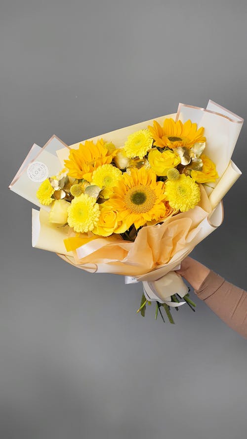 Free Yellow Flowers in Human Hand Stock Photo