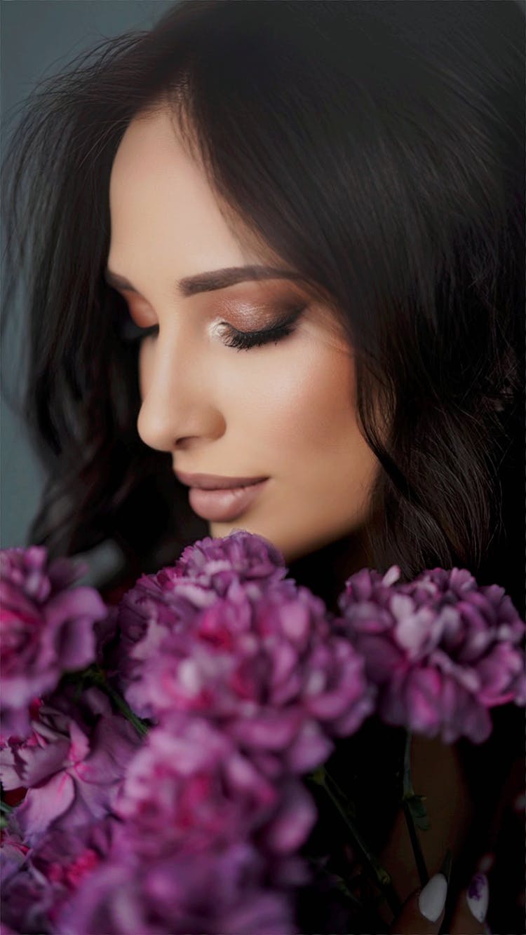 Portrait Of Black-haired Woman Holding Flower Bouquet