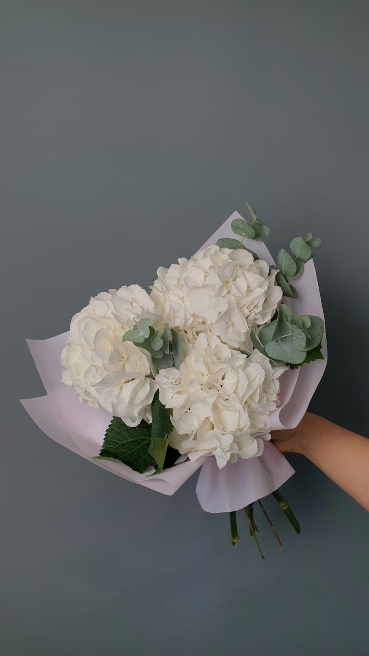 Hand Holding Bouquet Of Flowers