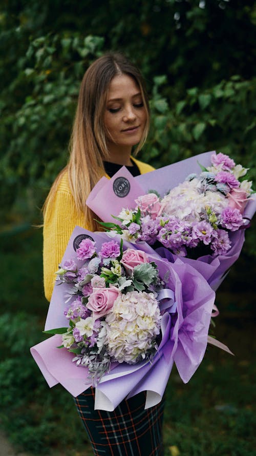 Free Woman Looking at Bouquets of Flowers Stock Photo
