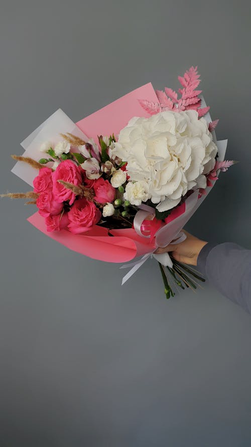 Free Hand Holding Bouquet of Flowers Stock Photo