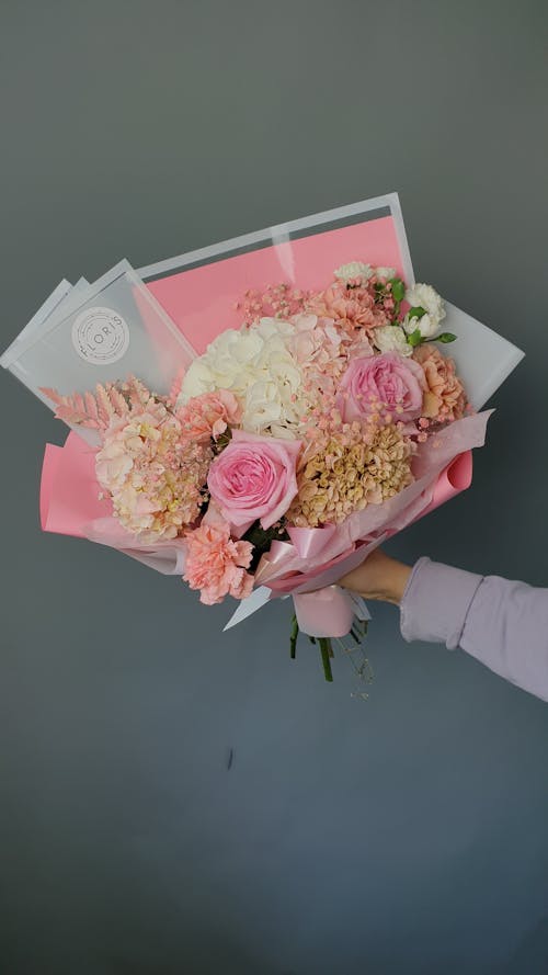 Free Human Hand Holding Bouquet of Flowers Stock Photo