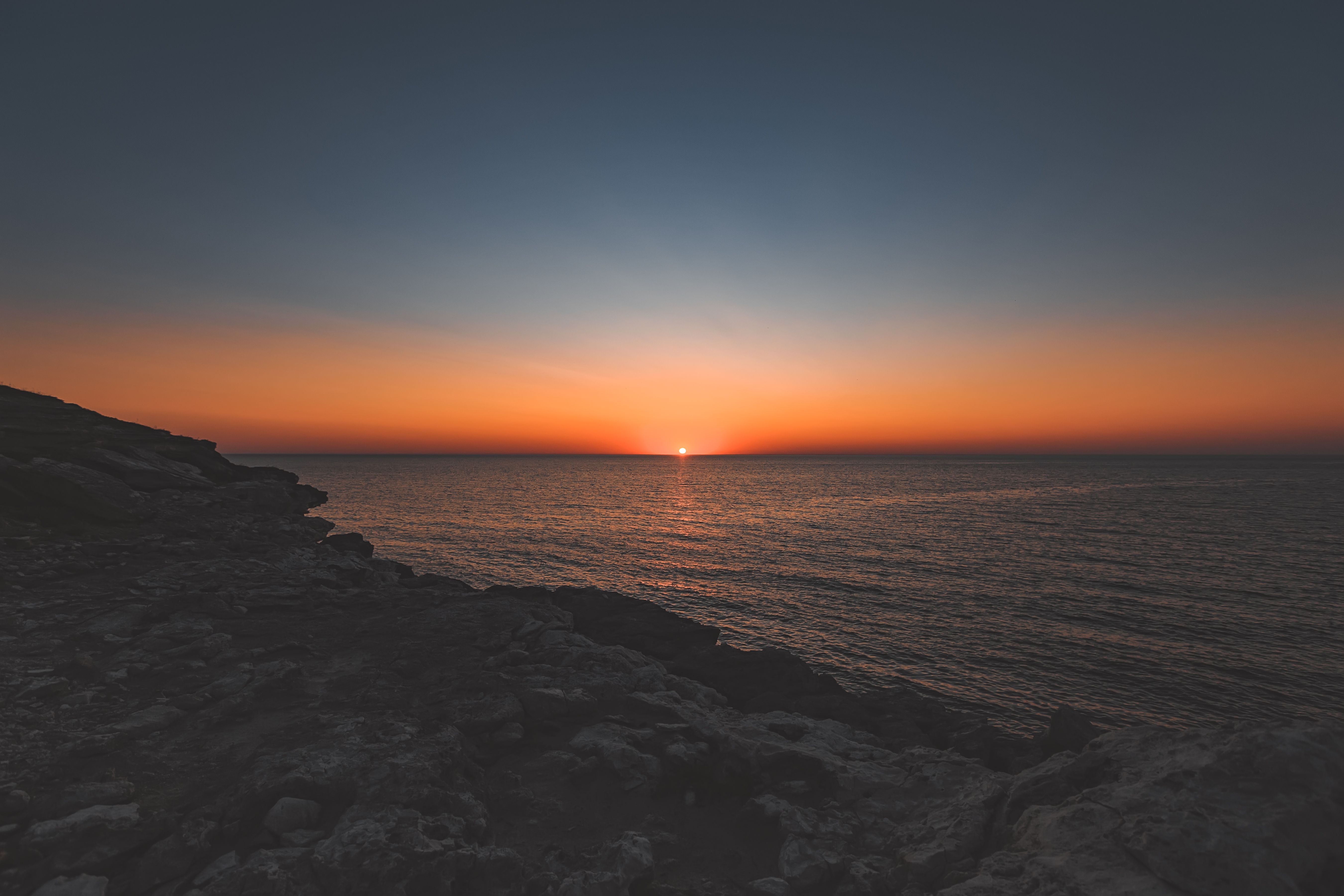 Black Rocky Shore during Sunset · Free Stock Photo