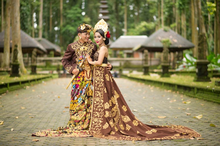 Photo Of Man And Woman Wearing Brown Floral Dress