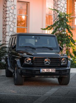 Front view of a luxury black Mercedes-Benz SUV parked outside a stylish building.