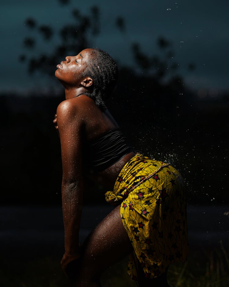 Woman In Yellow Skirt In Darkness