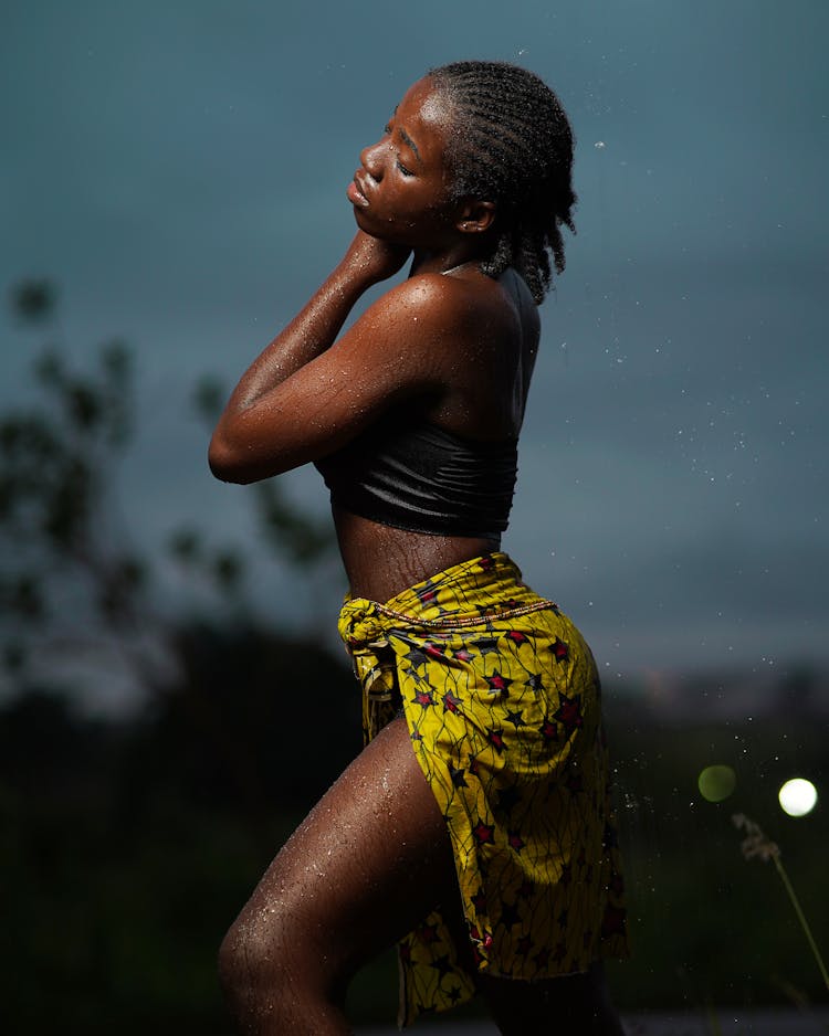 Woman In Yellow Skirt With Cloudy Sky In Background