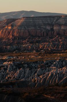 Explore the breathtaking geological formations of Cappadocia, Turkey, captured during a golden sunset.