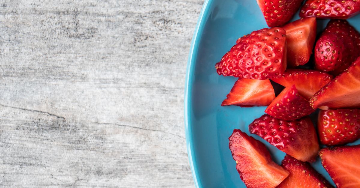 Can Dogs Eat Frozen Strawberries Can dogs eat frozen strawberries: sliced strawberries on a plate, cut into small dog-safe pieces