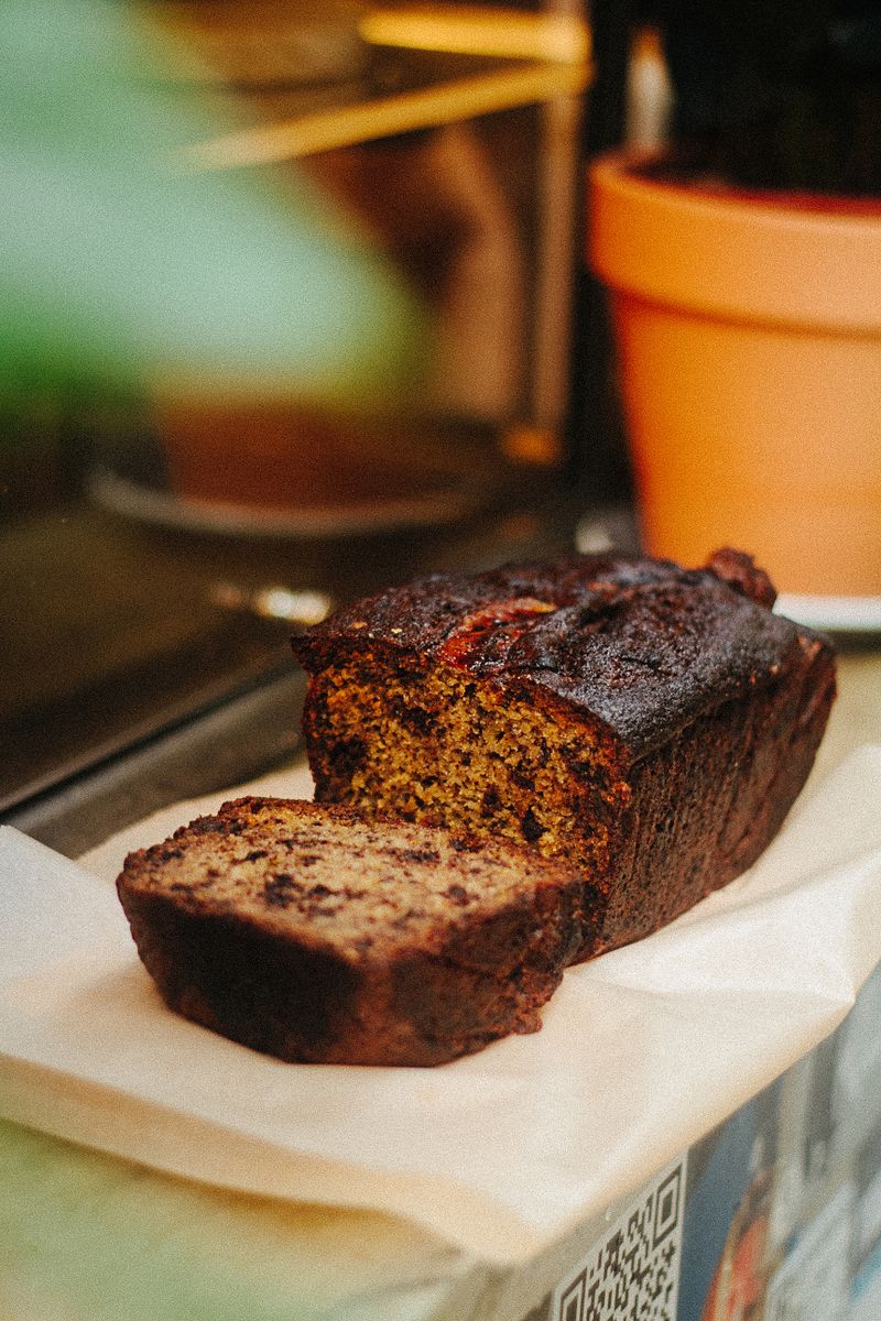 Sliced chocolate chip banana bread loaf with a gooey center