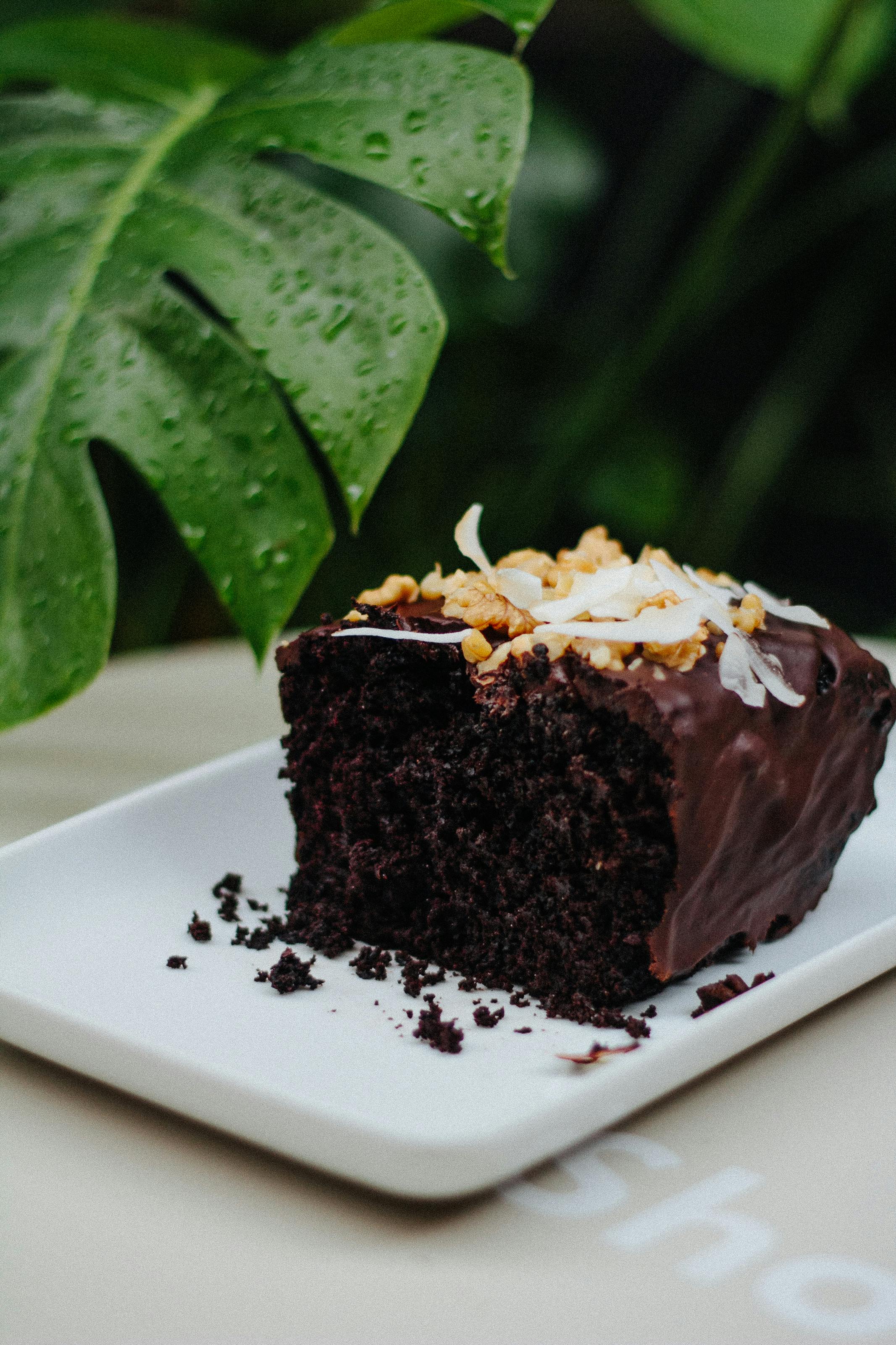 Hands preparing coconut cake layers in a kitchen