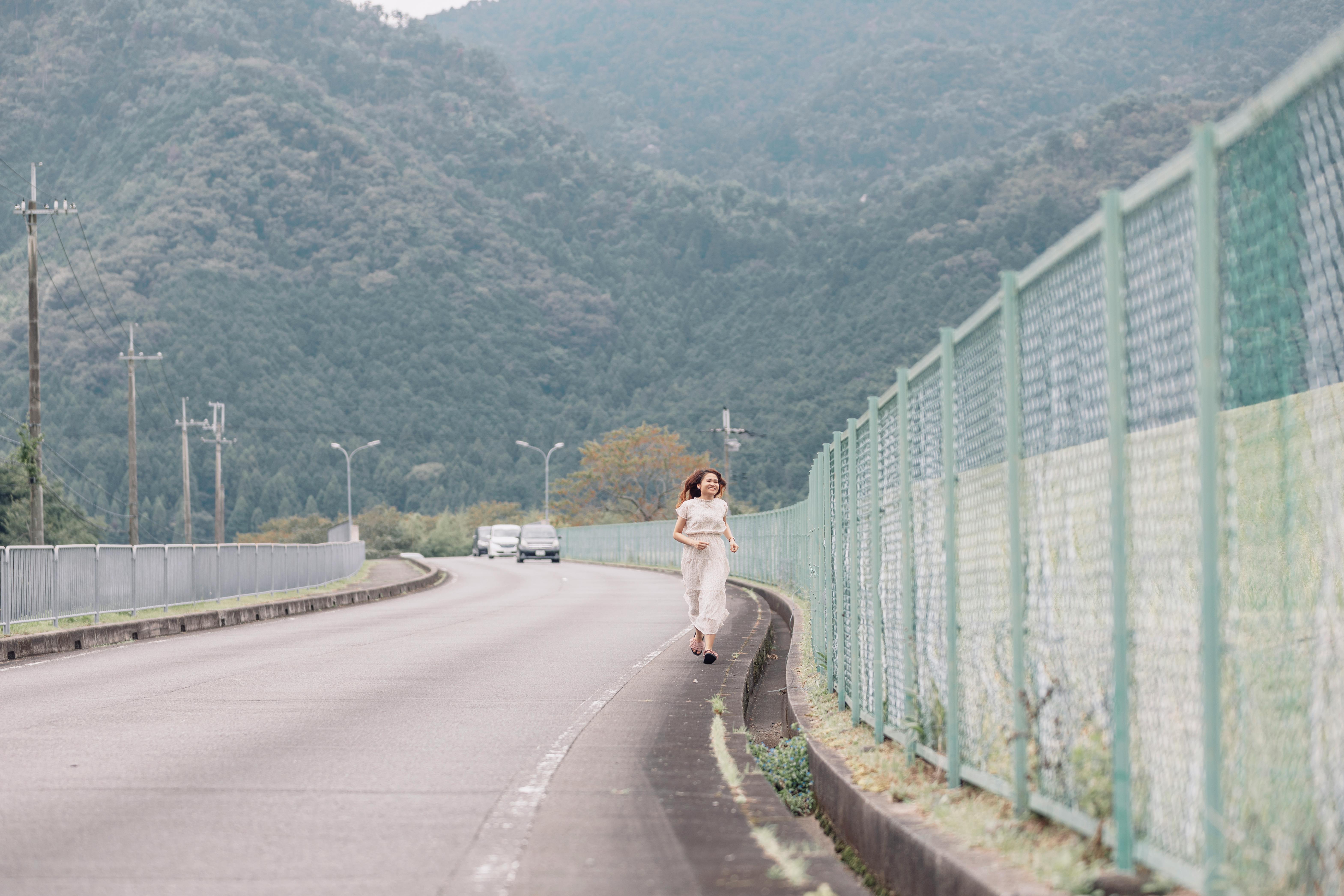 Girl in White and Purple Dress Walking Along Green Grass Field during ...