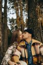 Woman Kissing a Man in Plaid Shirt