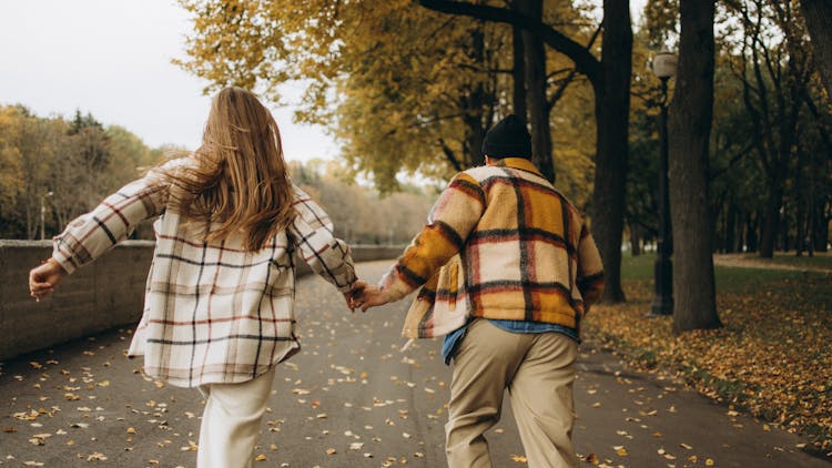 Photo Of Man And Woman Running