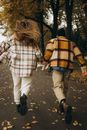 Back View Shot of a Couple Holding Each Others Hand While Running on a Pathway