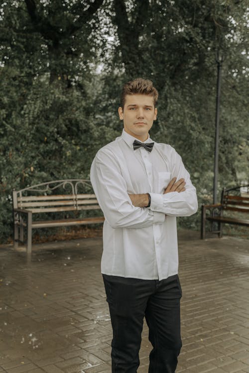 A Male Wearing a White Shirt With A Bow Tie 