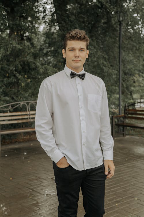A Male Wearing a White Shirt With A Bow Tie 
