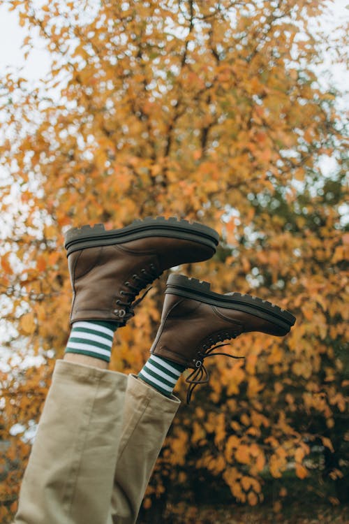 
A Person Wearing a Brown Boots and Beige Pants