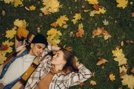 2 Women Lying on Yellow Flower Field