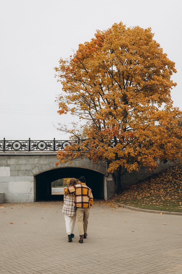 A Couple Walking On The Street