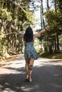 Woman in Black and White Floral Dress Standing on Road