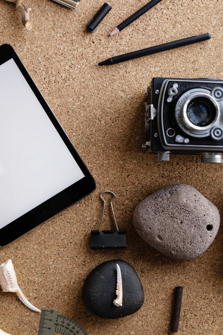 Tablet, Camera, Stone Camera And Items On Desk