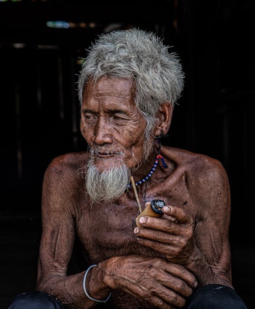 Elderly Man with Pipe in Hand