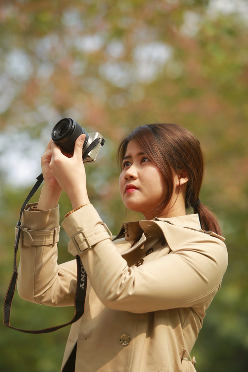Free Young woman photographing outdoors in Hanoi, Vietnam on a sunny day. Stock Photo