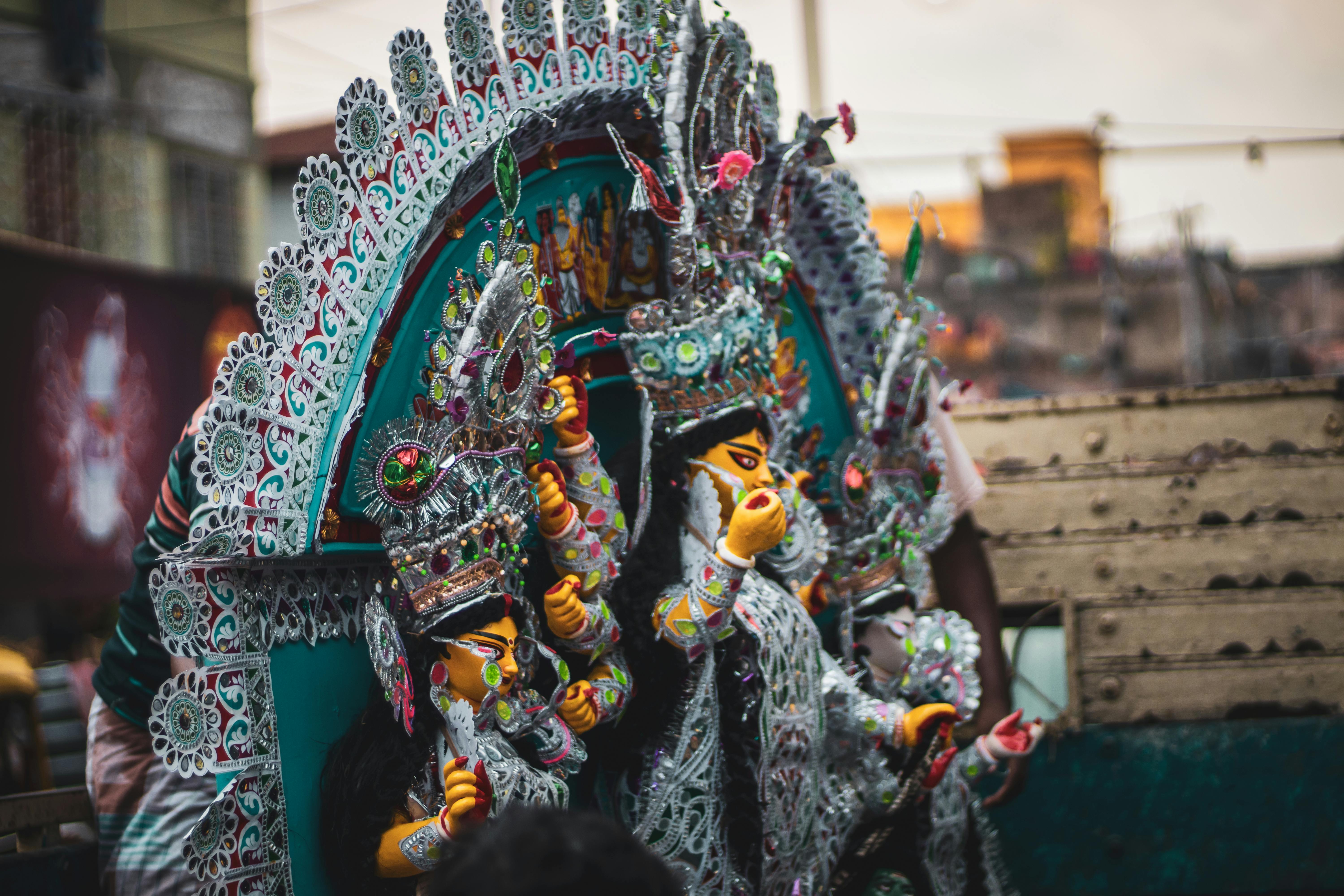 Colorful and ornate festival statues representing Indian cultural traditions and celebrations.