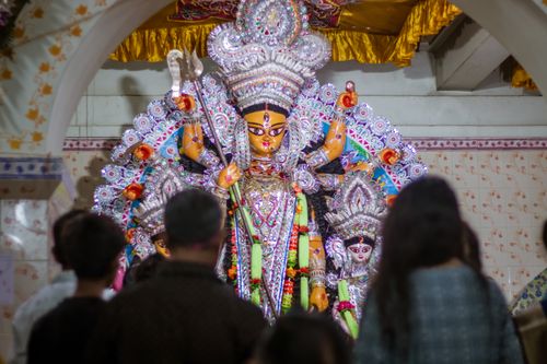 Free Colorful Durga maa idol worship during an Indian festival with people gathered around. Stock Photo