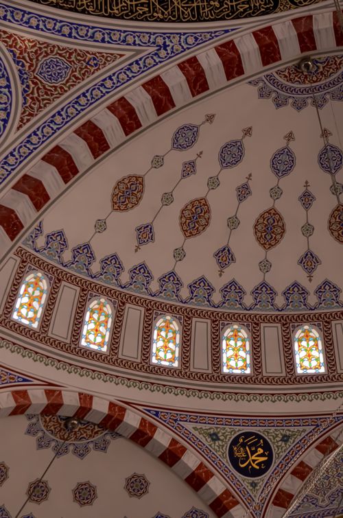 Free Closeup of an ornate mosque ceiling with intricate patterns and stained glass windows. Stock Photo