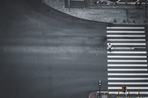 Aerial Shot of Person Walking on Pedestrian Crossing 