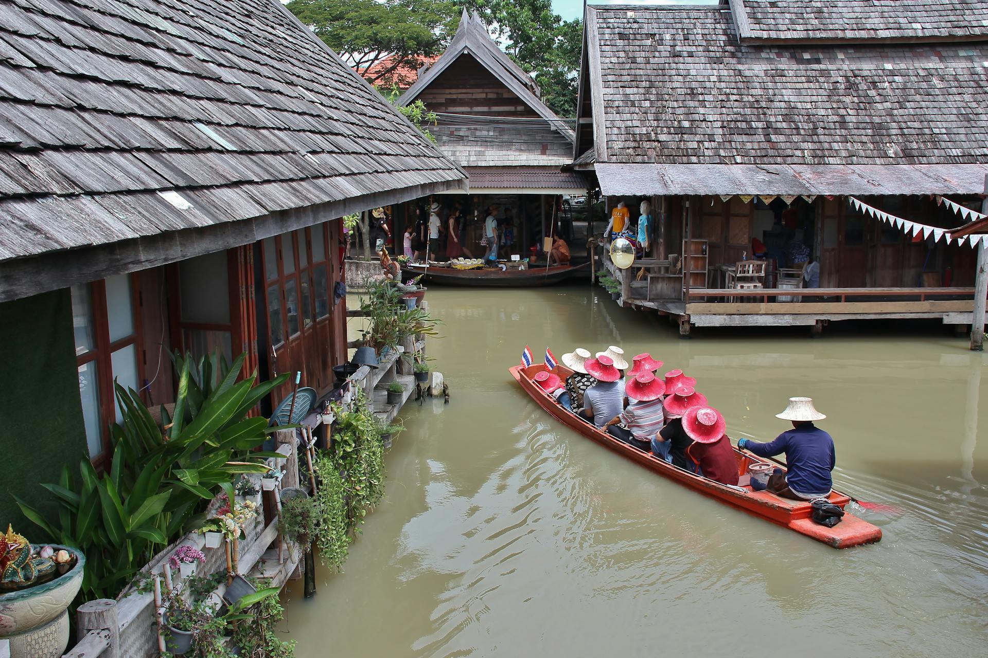 Experience a peaceful canal boat ride through traditional Thai architecture in Muang Pattaya.