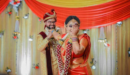 Photo of a Couple Wearing Traditional Decorative Clothing