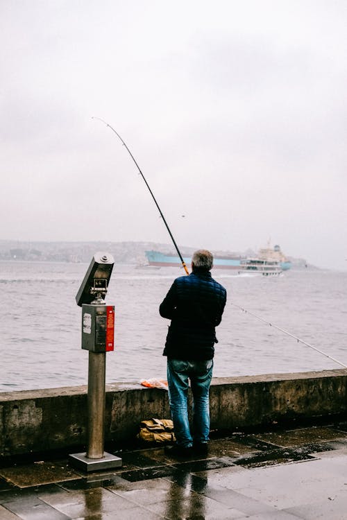 Back View Shot of a Man Fishing on the Sea