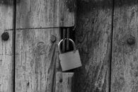 Gray Padlock on Wooden Door