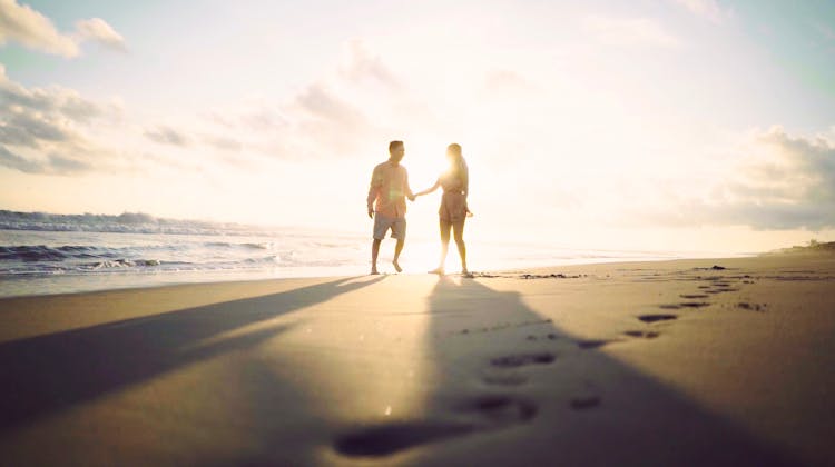 Couple Holding Hands At The Beach