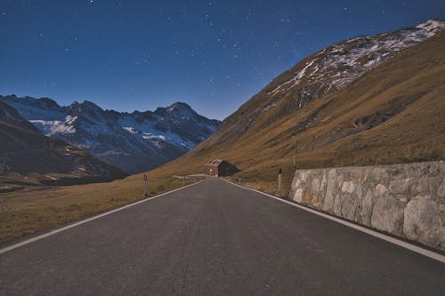Road in Mountains under Starry Sky