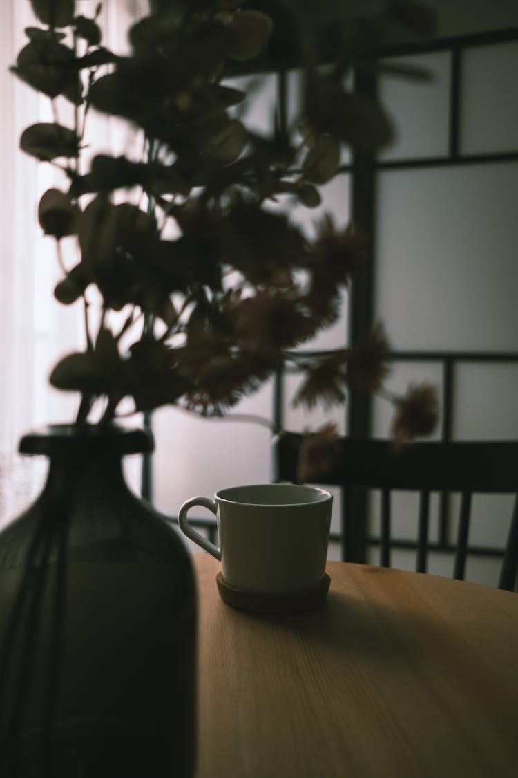 White Mug On Coaster On Table