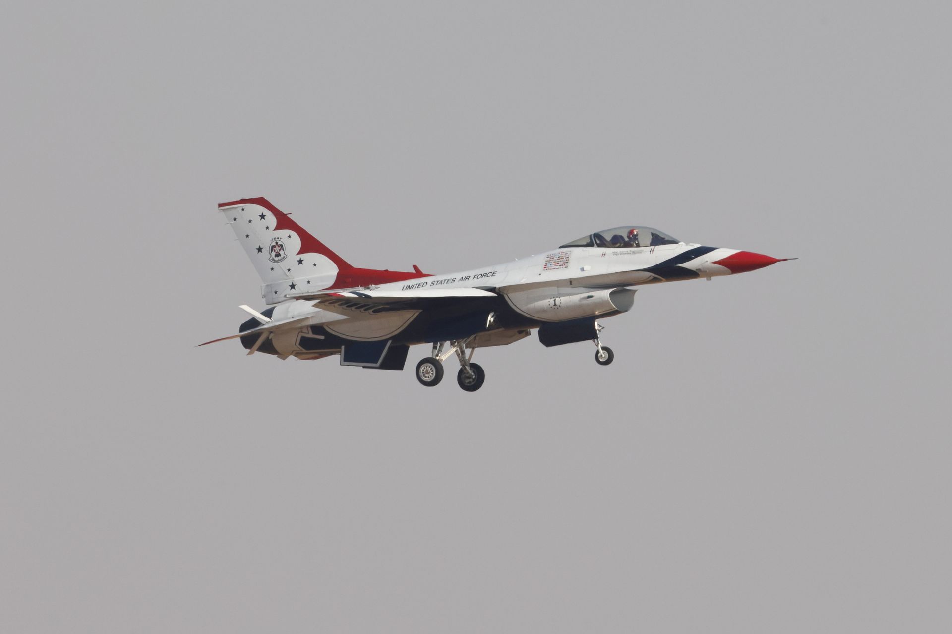 A United States Air Force Thunderbird F-16 jet gracefully flies through the sky.