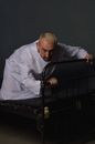 Man in White Dress Shirt Sitting on Black Wheelchair