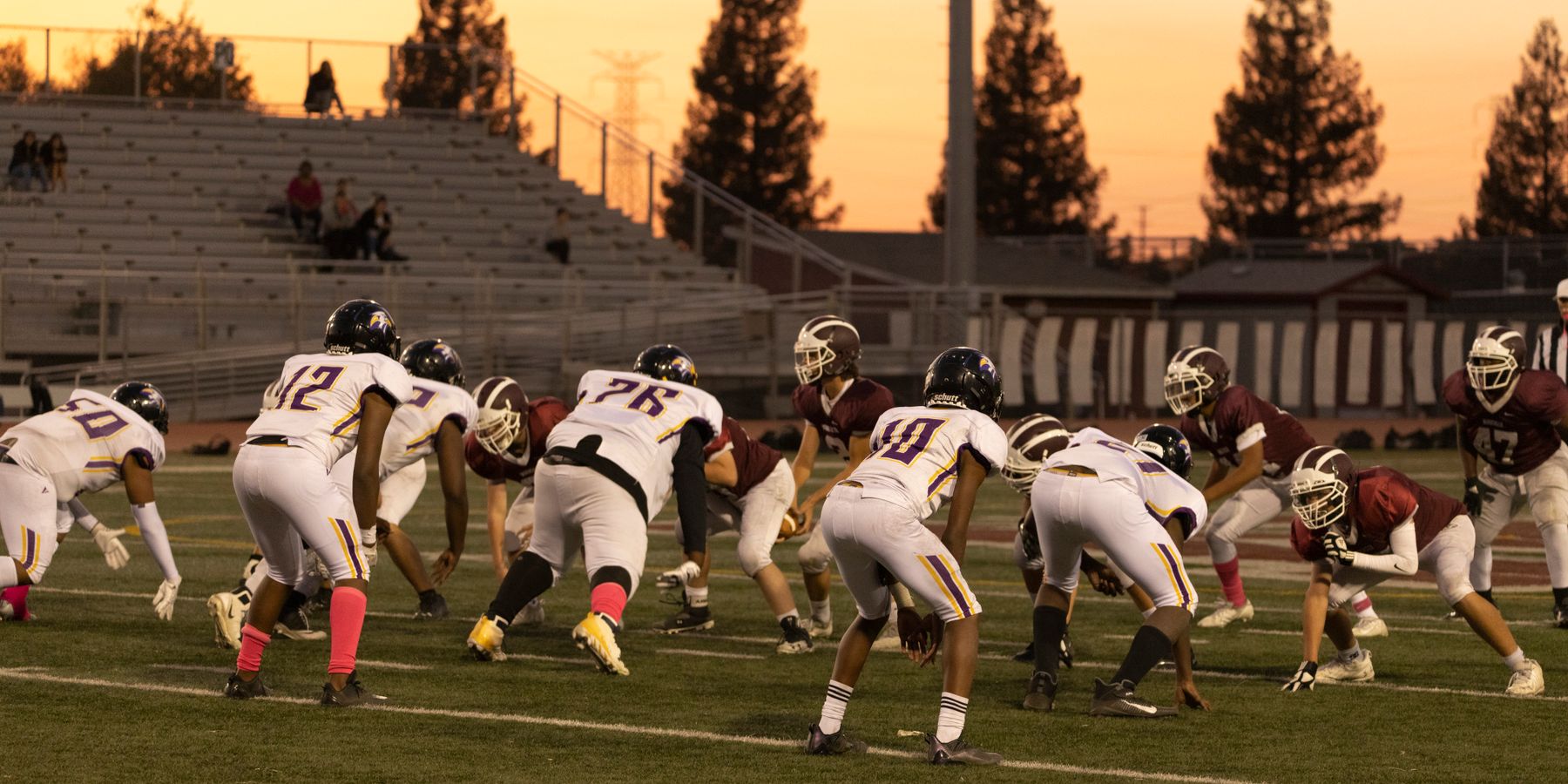 Intense American football game between two teams at sunset in Roseville, California.
