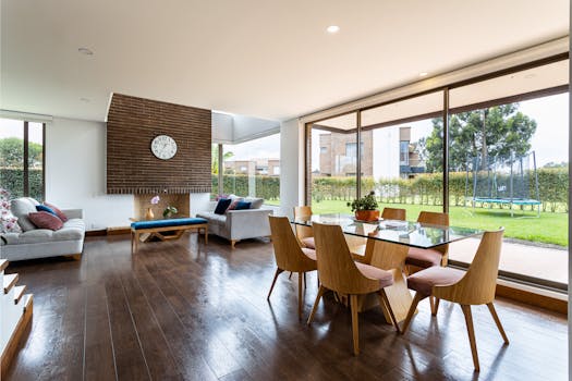 Spacious living and dining area with glass windows and modern furnishings.